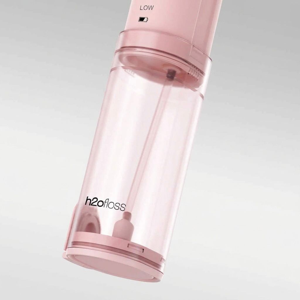 Pink h2ofloss device on a light gray background