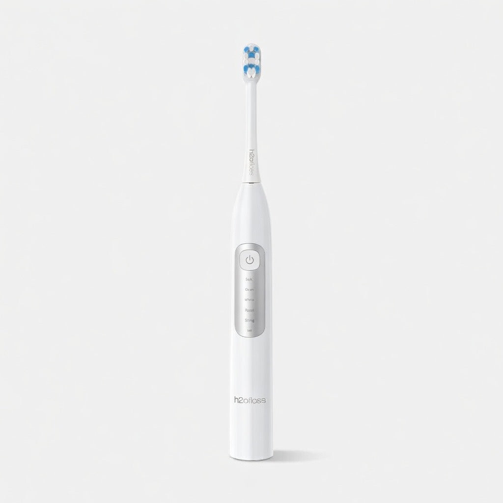 White electric toothbrush with blue bristles on a light gray background